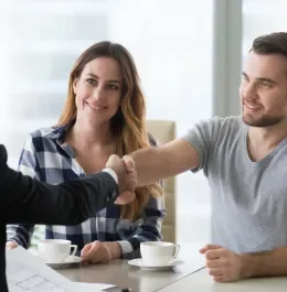 Homeowner shaking hands with our site lead after agreeing works